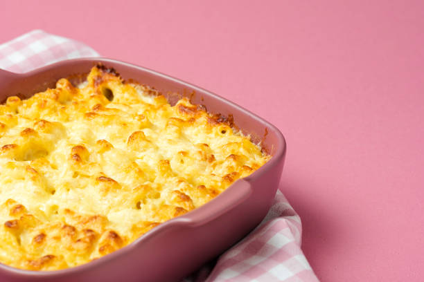 istock Macaroni and cheese in a pink oven tray. Mac and cheese close-up. 1255074579