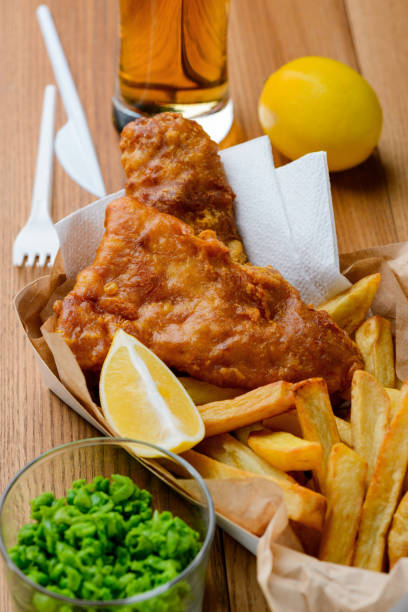istock Peas, lemon, fish and chips. Light meal in British style 1255075305