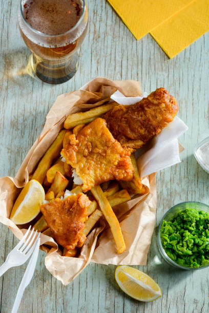 istock Fish and chips with peas and lemon slices 1255076517