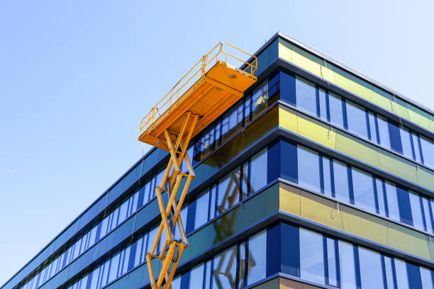 istock modern building facade repair using a high scissor lift with a platform 1255078631