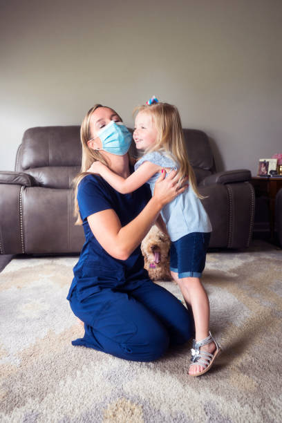 istock Hugging Mommy in her face mask 1255081411
