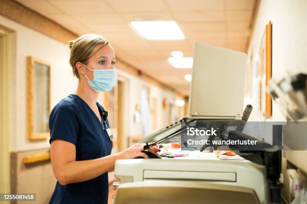 Nurse Documenting During Covid19 Stock Photo - Download Image Now - Nurse, Hospital, Computer