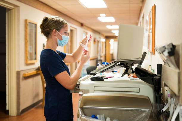 istock Nurse drawing up medicine in a syringe 1255081466