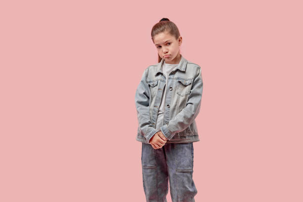 Cute beautiful girl looking at the camera with a sad face.