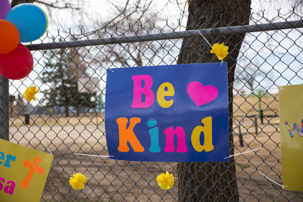 istock Be Kind sign on a chain link fence 1255085247