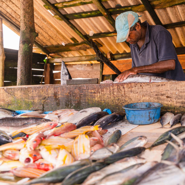istock Man selling fish at small local fish market 1255085962