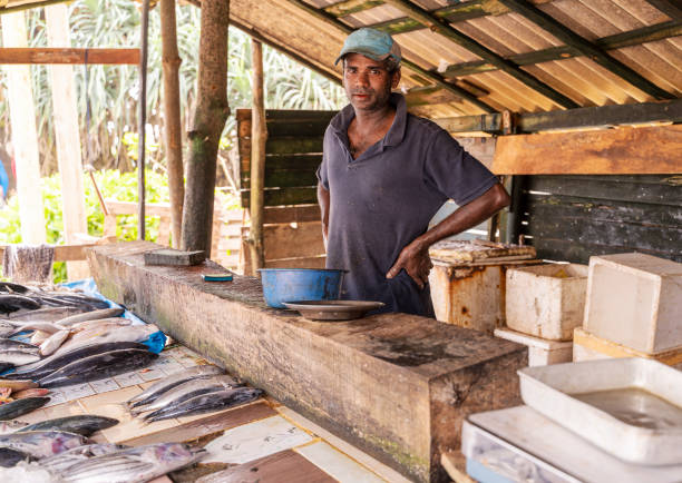 istock Man selling fish at small local fish market 1255085963