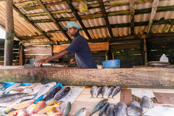 istock Man selling fish at small local fish market 1255085977