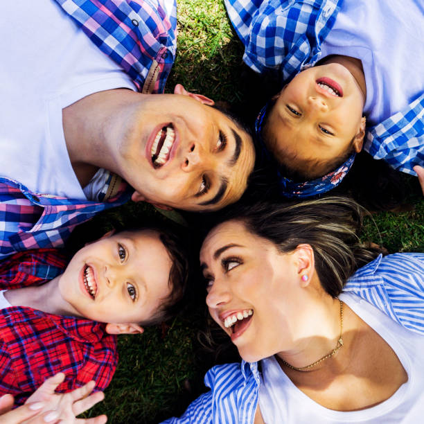 istock Loving family lying down on grass having fun talking and smiling 1255091120