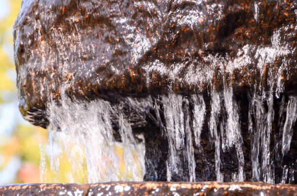 water flowing over rocks in a small waterfall in a canal