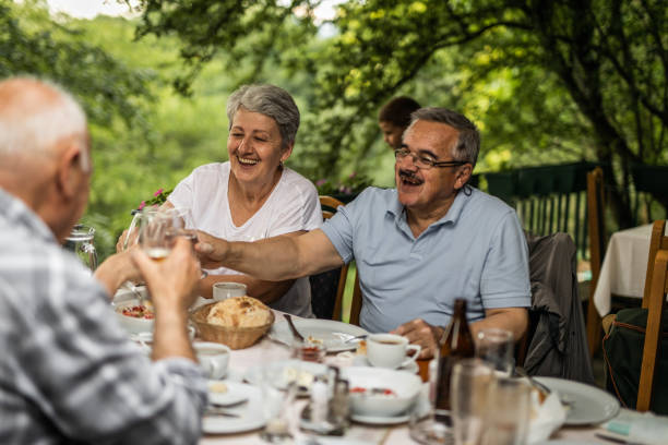istock Mature friends enjoying in lunch in back yard 1255095146