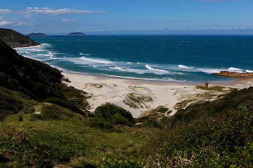 Guarda do Embau beach dunes view from rocks trail at Madre river bed. Tropical paradise of lush vegetation and natural reserve, famous for fishing surfing lifestyle, summer vacation travel destination