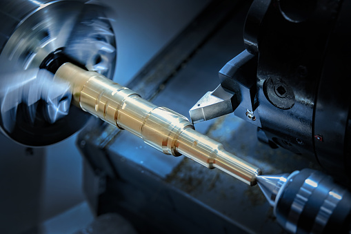 Worker tighten screws of Metalworking CNC milling machine