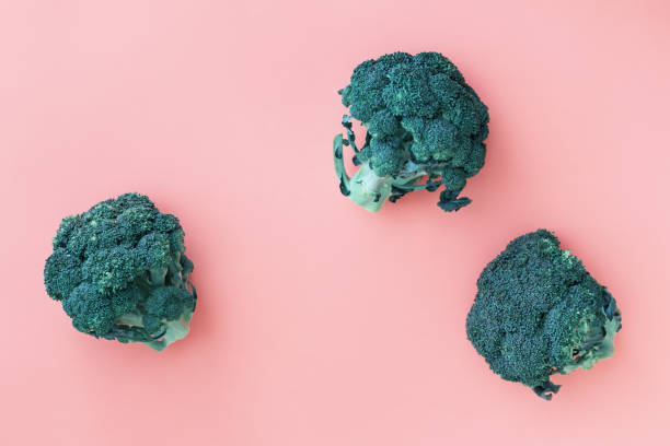 istock Fresh green broccoli on pink background 1255098835