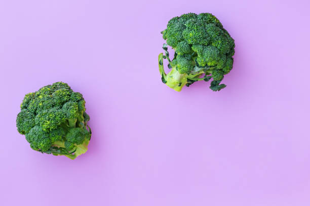 istock Fresh green broccoli on pink background 1255098921