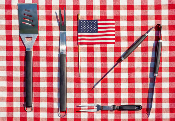 istock Flat lay of metal grill tool slayed out on a picnic table ready for a barbecue 1255100600