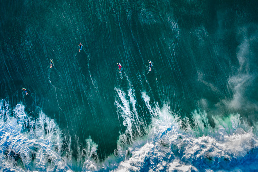 man surfing waves on bali beach