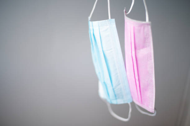 istock Pink and blue surgical mask on blur background.Covid-19 concept. 1255102490