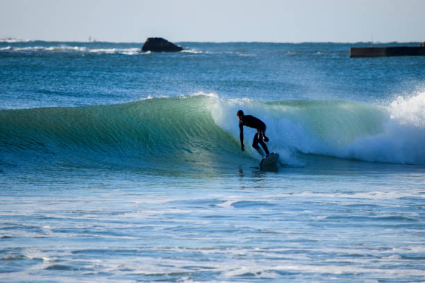 istock Surfer on Blue & green Ocean Wave riding a surfboard 1255102546