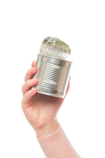 istock metal tin can isolated in human hand on the white background 1255104088