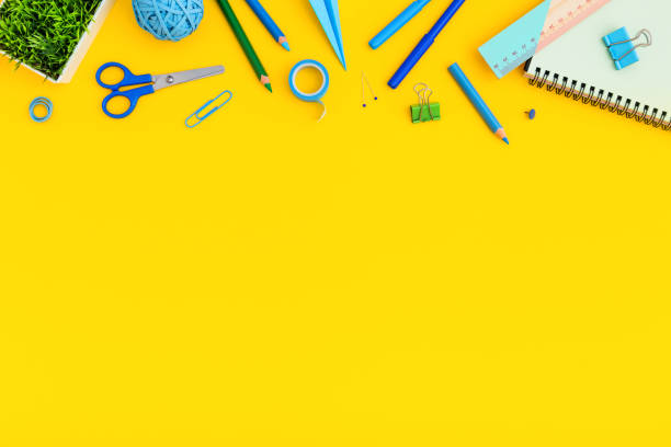 istock Blue stationery on yellow background. Creative flat lay. Back to school concept. 1255104111