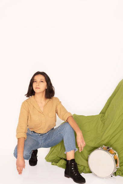 cool young girl sits like a rapper in front of green background. - singing singer teenager contest imagens e fotografias de stock