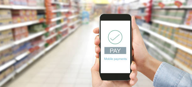 istock Hand holding smartphone device touching screen, Mobile payment with wallet app 1255113030