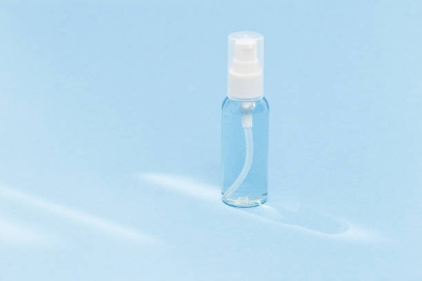 istock Transparent bottle with cosmetic product, soap or shampoo on blue colored background. Bright daylight. Beauty blogger, salon treatments concept. Minimalism. 1255119081