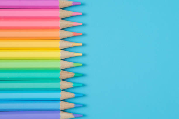 istock Colorful Pattern of Pastel colored pencils on blue background and copy space 1255119924