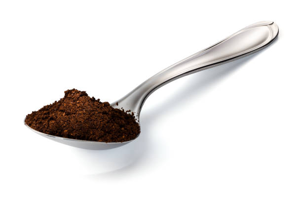 istock Scoop of Ground Coffee in a Spoon Isolated on a White Background 1255120268