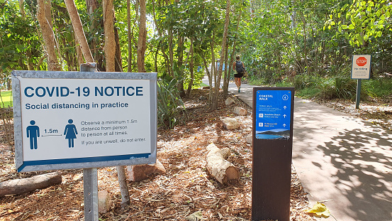 Warning signs at Noosa Heads National Park due to covid-19 restrictions.