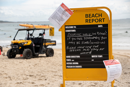 A beach report with restrictions due to coronavirus. Lifeguard quadbike can be seen in the background.