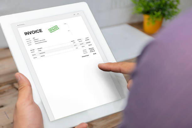 istock Close-up of businessman's hands working on invoice 1255125229