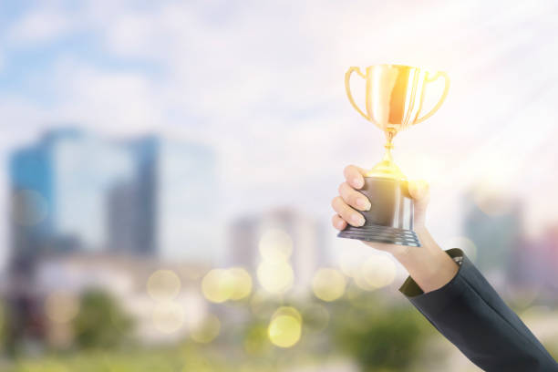 istock Business women hold a trophy 1255125230