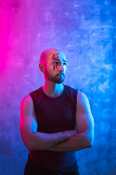 istock Portrait of man with fluorescent drawings on face. 1255126684