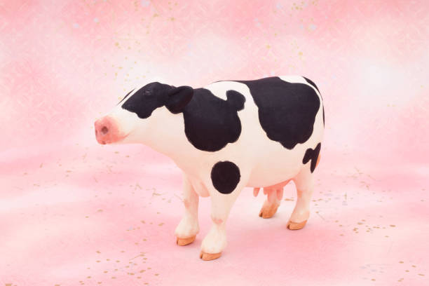 istock A cow sculpture made of clay on a pink background. 1255134902
