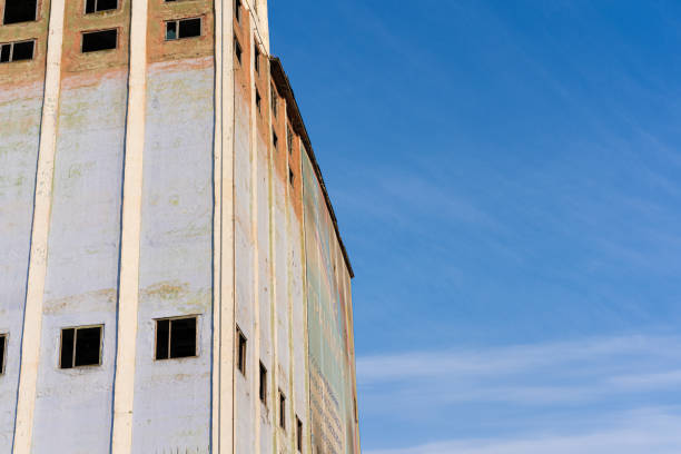 istock Old abandoned high-rise building with broken windows 1255139263
