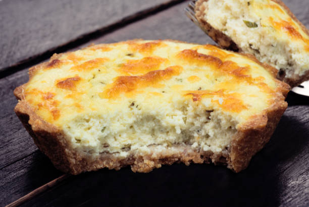 istock Cut wholemeal ricotta cheese quiche in black background 1255139372
