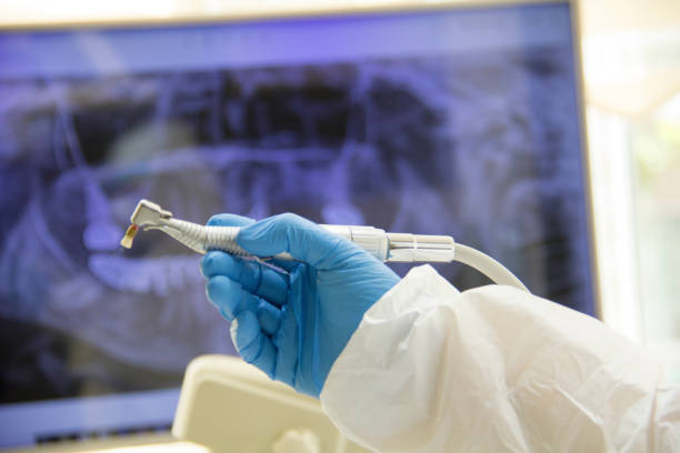 istock Dentist holding an x-ray on white background. 1255142746