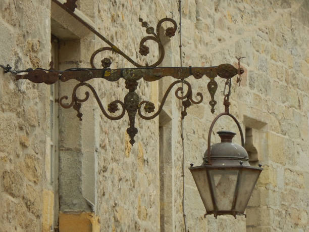 istock Antique hand-wrought iron bracket with hanging lantern 1255142992