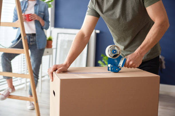 istock Hands of man using a adhesive tape for packing 1255143231