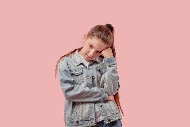 istock Hand prop your head. Cute beautiful girl with a sad face. 1255147290