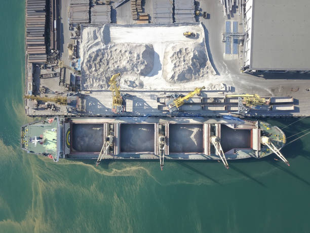 istock Container ship in export and import business and logistics. Shipping cargo to harbor by crane. Water transport International. Aerial view 1255149949