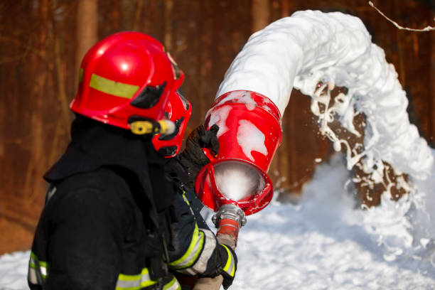istock Firefighters extinguish a fire. Rescuers with fire hoses with foam. 1255150756