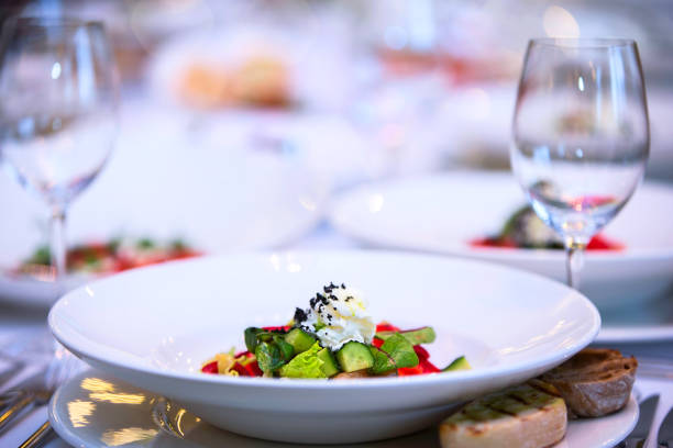 istock White plate with salad on a restaurant background. 1255150870