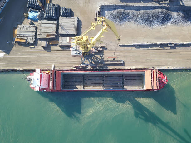 istock Container ship in export and import business and logistics. Shipping cargo to harbor by crane. Water transport International. Aerial view 1255152339