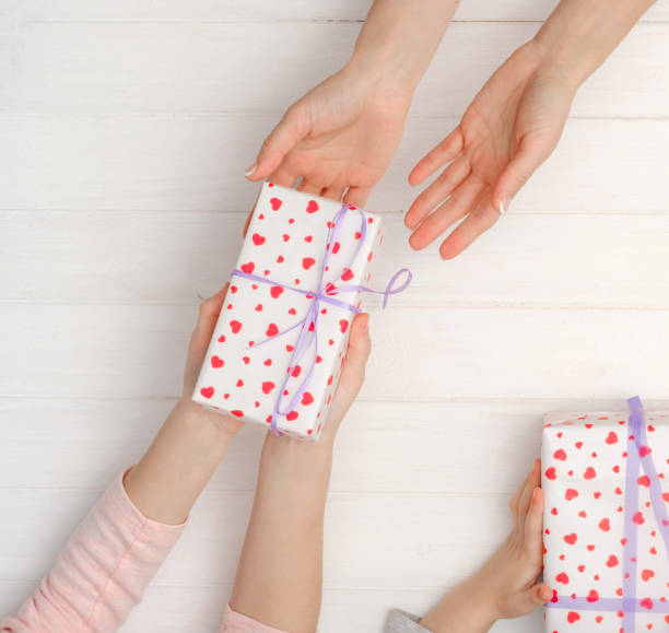 istock Girls hands holding lovely present box 1255153377