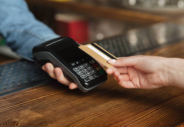 istock Quick and easy pay bill. Customer pays for drinks with credit card at terminal 1255153854