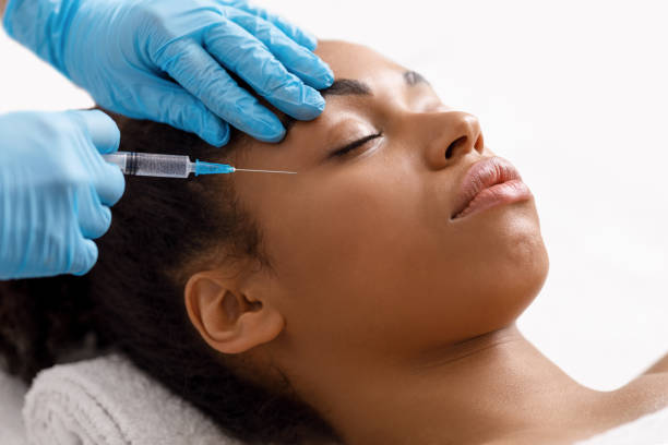 istock Black woman getting eye injection at salon 1255153918
