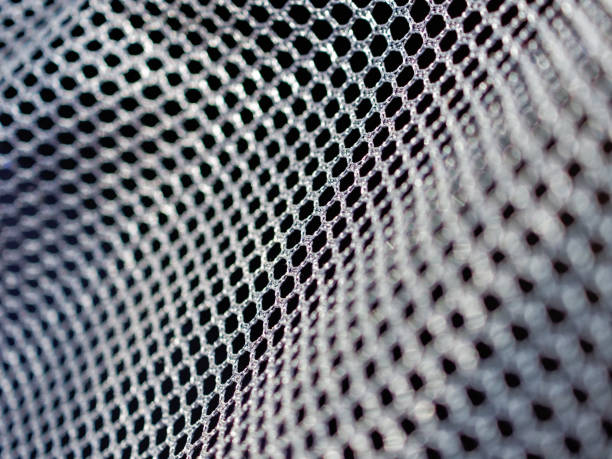 Black polyester mesh with large holes for free air circulation. Material for sportswear, animal carriers and others. Macro image. Black polyester mesh with large holes for free air circulation. Material for sportswear, animal carriers and others. Macro image. mesh textile stock pictures, royalty-free photos & images